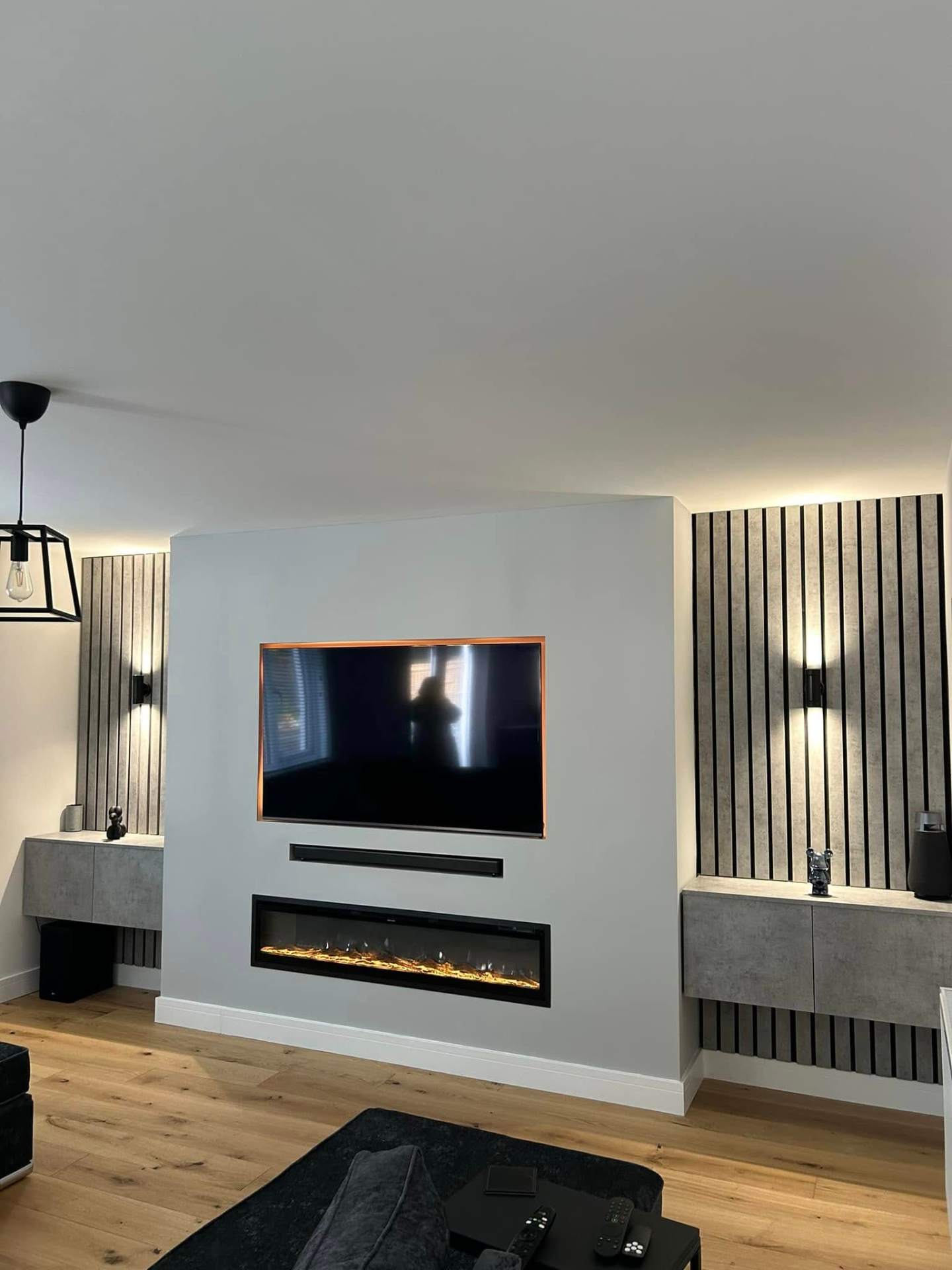 Modern grey media wall with electric fire & slat feature panels media wall in Suffolk