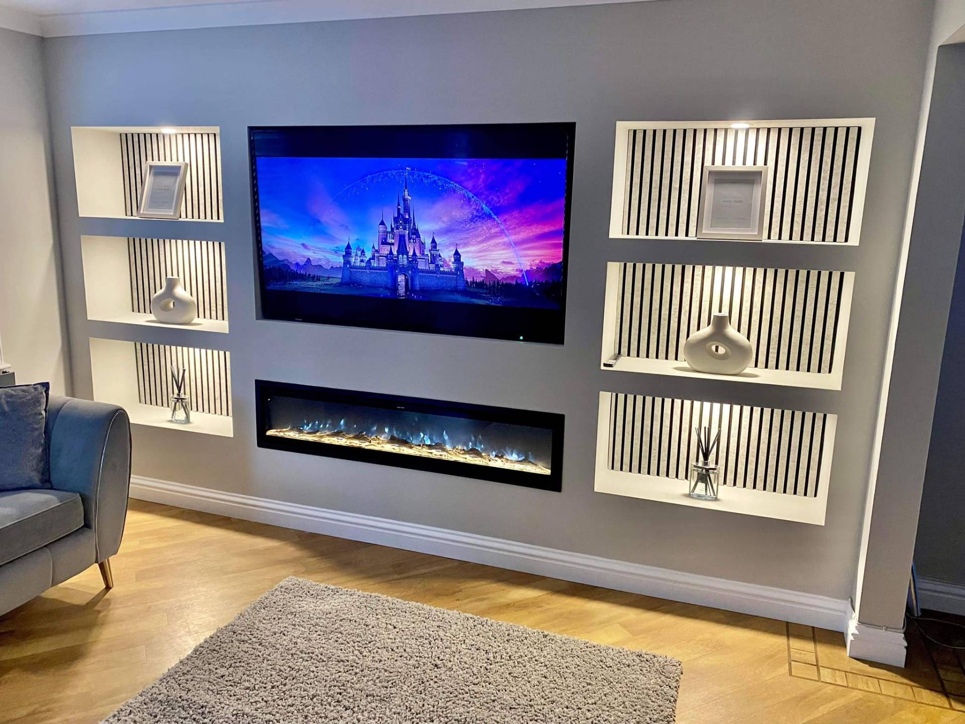 White media wall with slat panel shelving & panoramic electric fire media wall in Suffolk