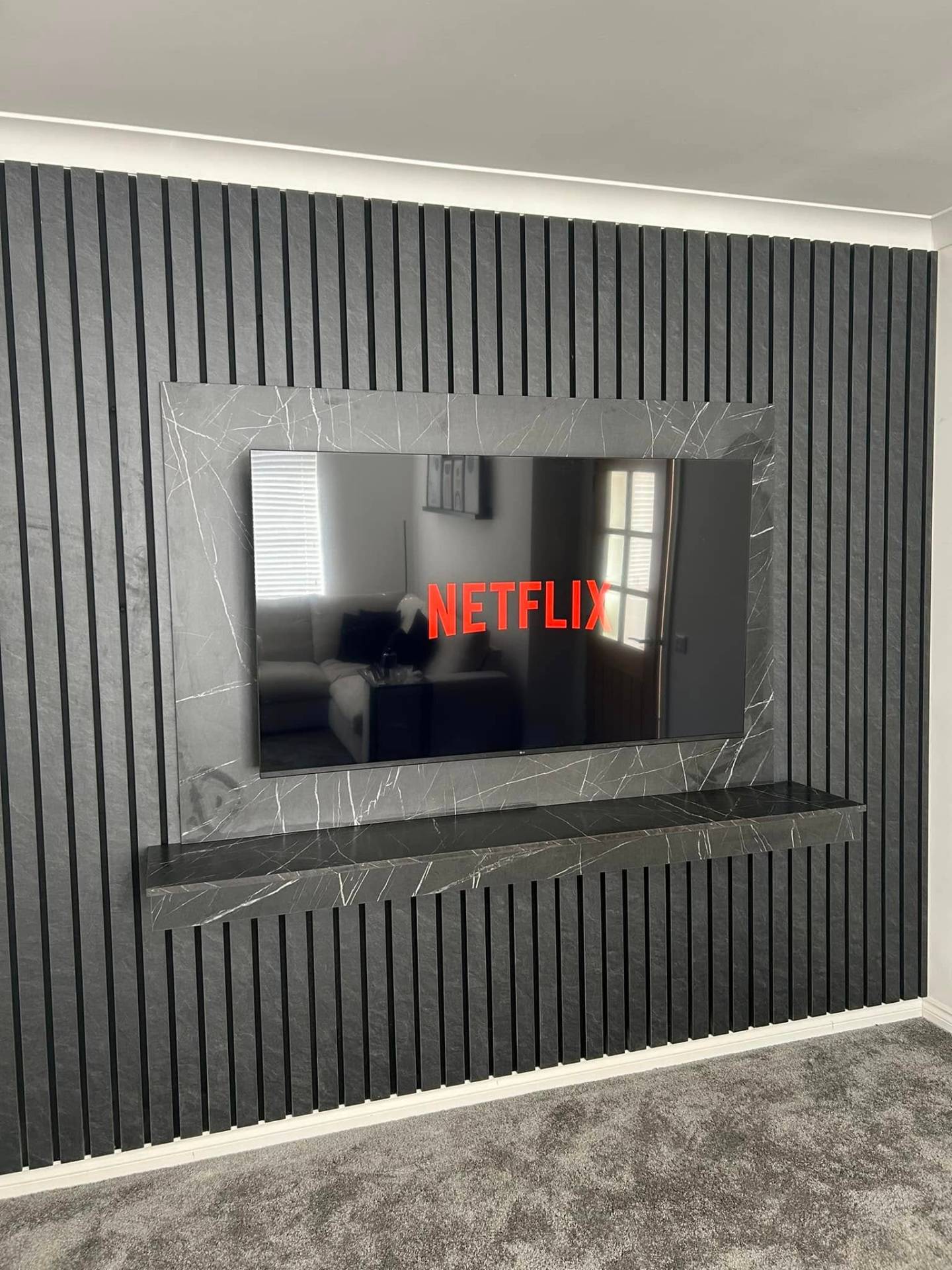 Black slat & marble feature wall media wall in Colchester, Essex