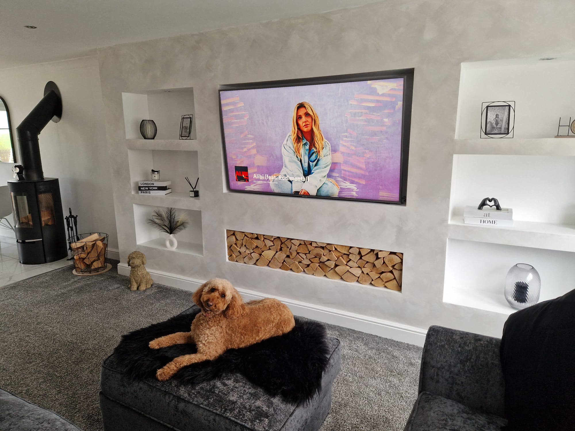 Modern living room media wall with log feature media wall in Norwich, Norfolk