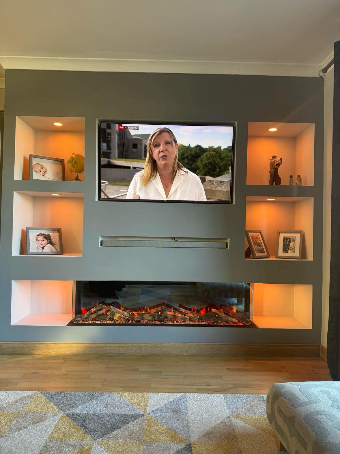 Sage green media wall with alcove shelving & electric fire media wall in Chelmsford, Essex