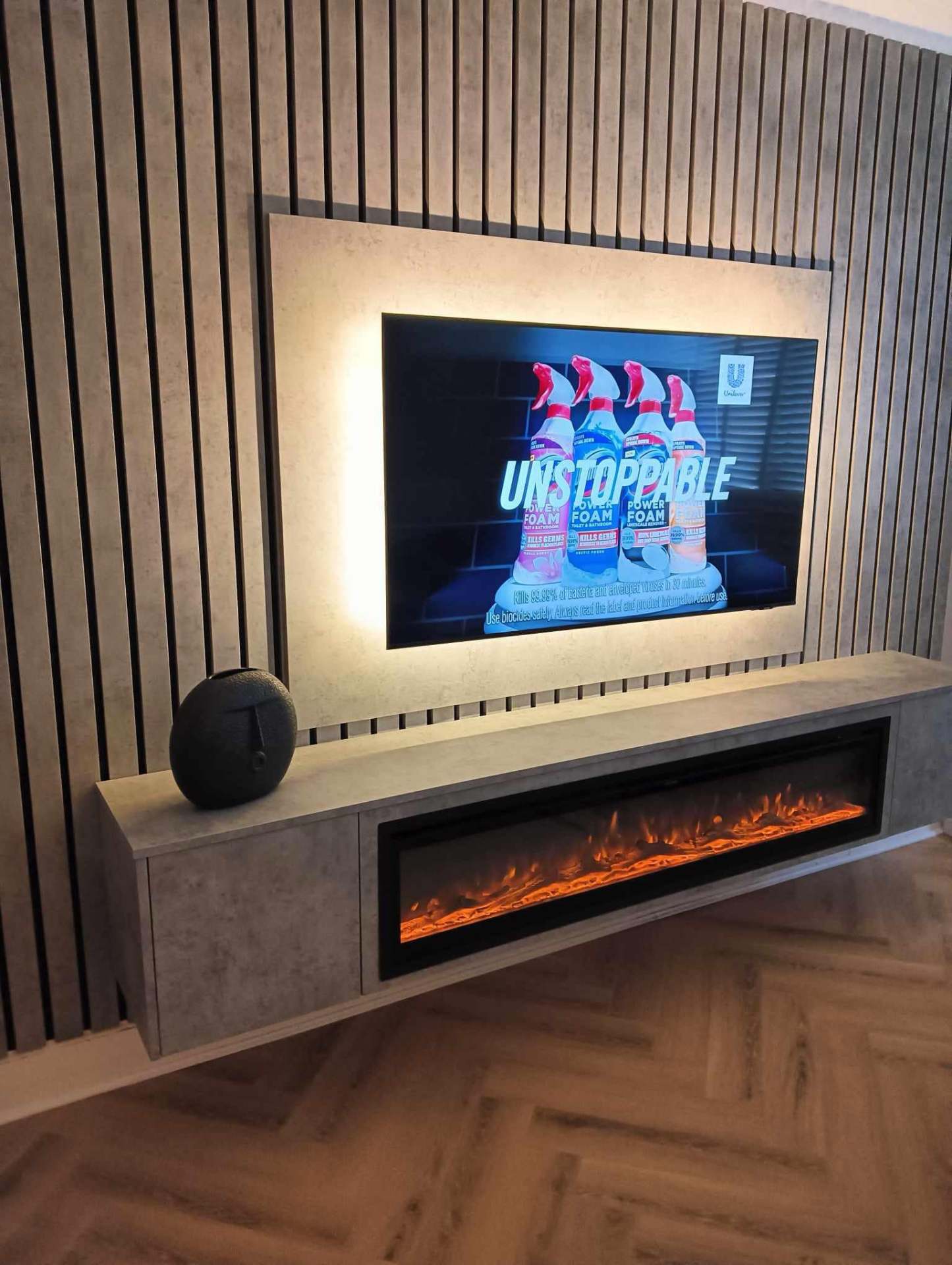 Slat wall media unit with concrete-effect surround & panoramic fire media wall in Chelmsford, Essex